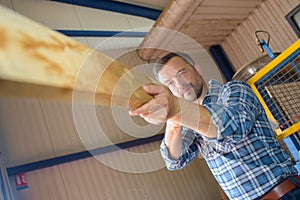 Man checking straightness piece wood