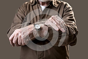 Pensioner showing his wristlet watch