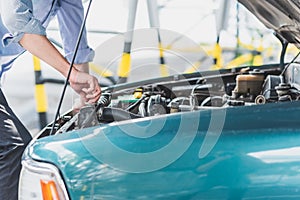 Man checking water leveling in radiator