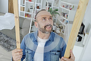 Man checking wood at home