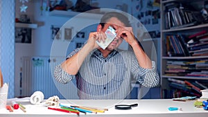 A man checks a banknote of 20 euros for authenticity