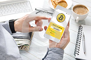Man checks bitcoin rate at his cryptocurrency wallet