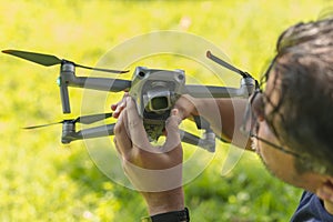 A man checks his drone gimbal for dust or any defects prior to flying. Drone safety and upkeep