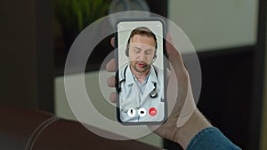 Man checks possible symptoms with professional physician, using online video chat. Young Man sick at home using