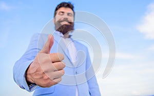 Man cheerful bearded businessman show thumbs up sky background. Hipster show thumbs up. Success and approval concept