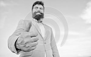 Man cheerful bearded businessman show thumbs up sky background. Hipster show thumbs up. Success and approval concept