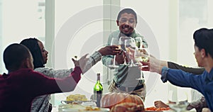 Man, cheers and friends toasting at dinner table for friendship, gathering or celebrating new year at home. Happy people