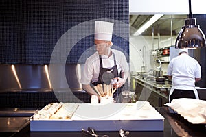 Man, chef and food in kitchen of restaurant for catering industry for meal with hospitality or fine dining with