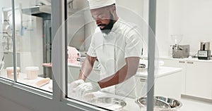 Man, chef and kneading dough on a restaurant kitchen counter for cooking job. Black person or professional baker working