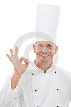 Man, chef and OK hand sign with smile for perfection, approval or precision isolated on a white studio background