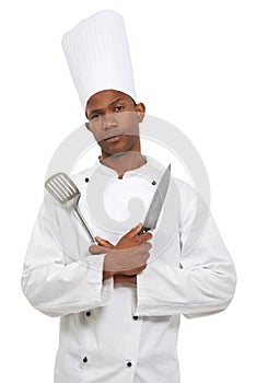 Man, chef and portrait with spatula knife in studio isolated on white background. Face, cooking professional or kitchen