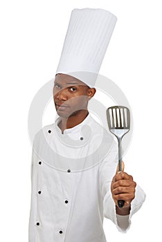 Man, chef and portrait with spatula tool in studio isolated on white background. Face, professional cook and kitchen