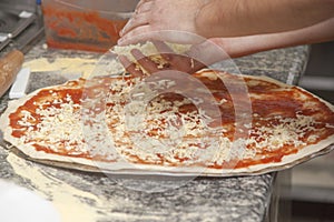 Man chef with raw pizza.