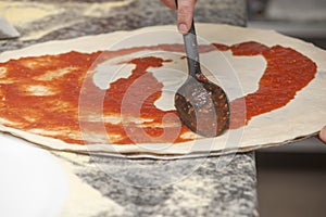 Man chef with raw pizza.