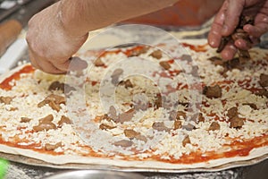 Man chef with raw pizza.