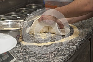 Man chef with raw pizza.