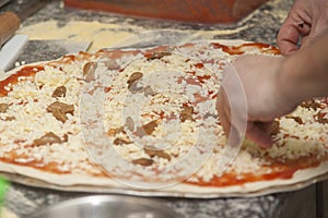 Man chef with raw pizza.