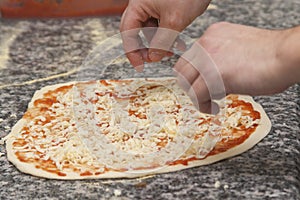 Man chef with raw pizza.