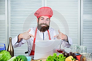 Man chef searching internet recipe cooking food. Elearning concept. Chef laptop read culinary recipes. Culinary school