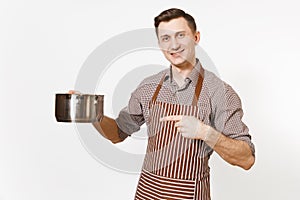 Man chef in striped brown apron holding silver stainless glossy aluminium empty stewpan, pan or pot isolated on white