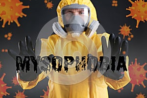 Man in chemical protective suit against background. Mysophobia