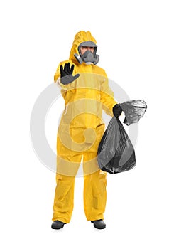 Man in chemical protective suit holding trash bag on white background. Virus research