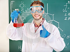 Man chemistry student with flask.