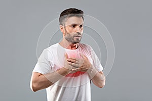 Man with chest pain touching inflammated zone