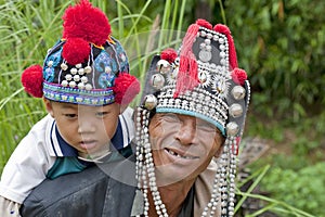 Man with child in Asia, Akha