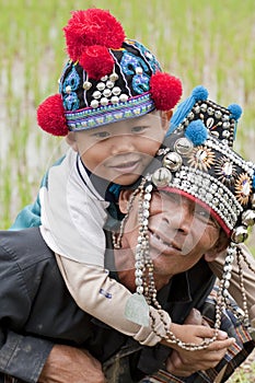 Man with child in Asia, Akha