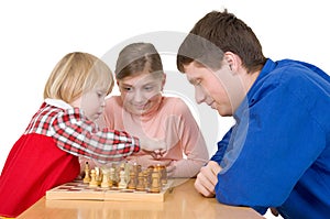 Man and child play chess