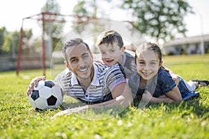 Man with child playing football on field