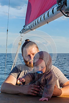 Man with a child on a sailing ship