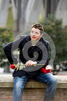Man with chocolates and a rose being stood up photo