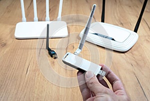 Man choose of different types of Wi-Fi routers, modern and old technology. Wireless ethernet connection signal. USB Wifi Receiver