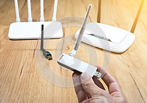 Man choose of different types of Wi-Fi routers, modern and old technology. Wireless ethernet connection signal. USB Wifi Receiver