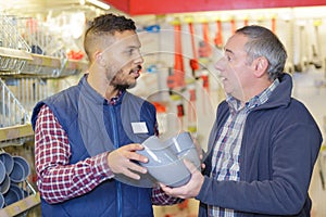 Man chooses connecting plastic pipes for plumbing faucet