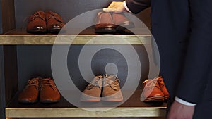 A man chooses shoes to buy in a shoe store