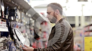 Man chooses sporting goods in store