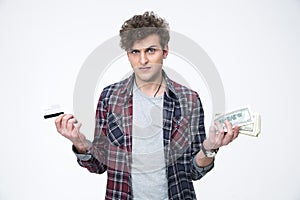 Man choosing between banking card or cash