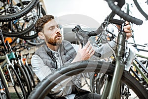 Man choosing bicycle at the store