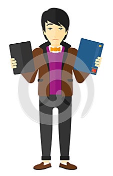 Man choosing between book and tablet computer