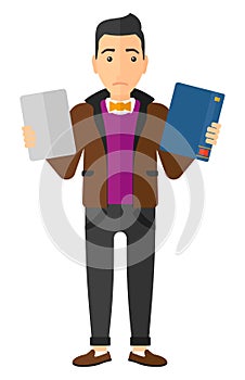 Man choosing between book and tablet computer