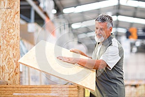 Man choosing and buying construction wood in a DIY store