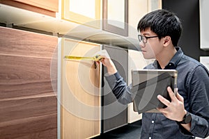 Man choosing cabinet material in furniture store