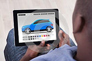 Man Choosing Car`s Color On Digital Tablet