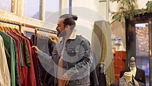 Man choosing clothes at vintage clothing store