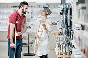 Man choosing crutches in the pharmacy