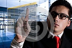 Man choosing flight at airport on a digital futu