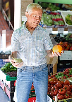 Man choosing fruits in market
